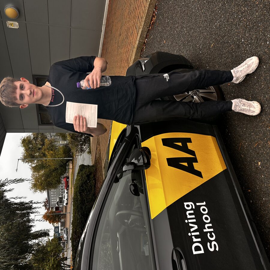 Archie holding his practical driving test pass certificate