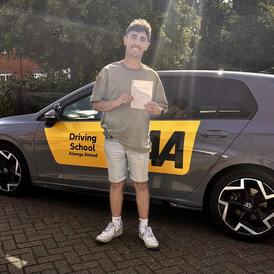 Callum holding his practical driving test pass certificate