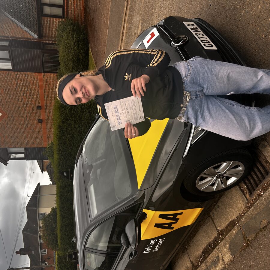Emily holding her practical driving test pass certificate