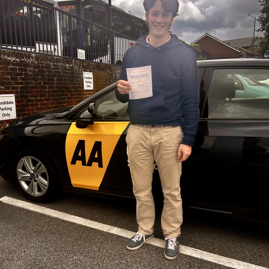 Freddie holding his practical driving test pass certificate