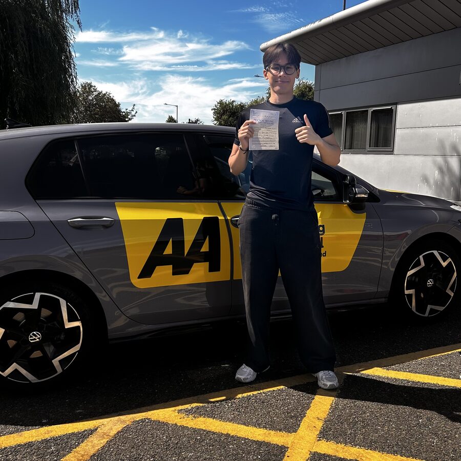 Jeremy holding his practical driving test pass certificate