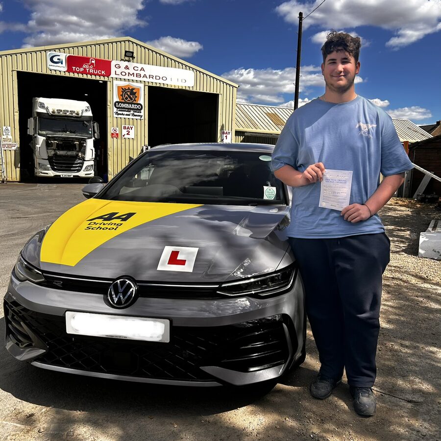 Keaton holding his practical driving test pass certificate