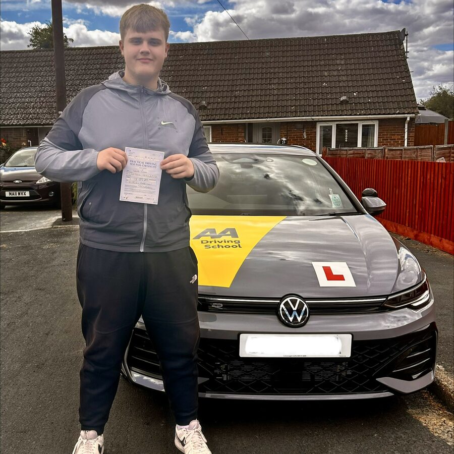 Lewis holding his practical driving test pass certificate