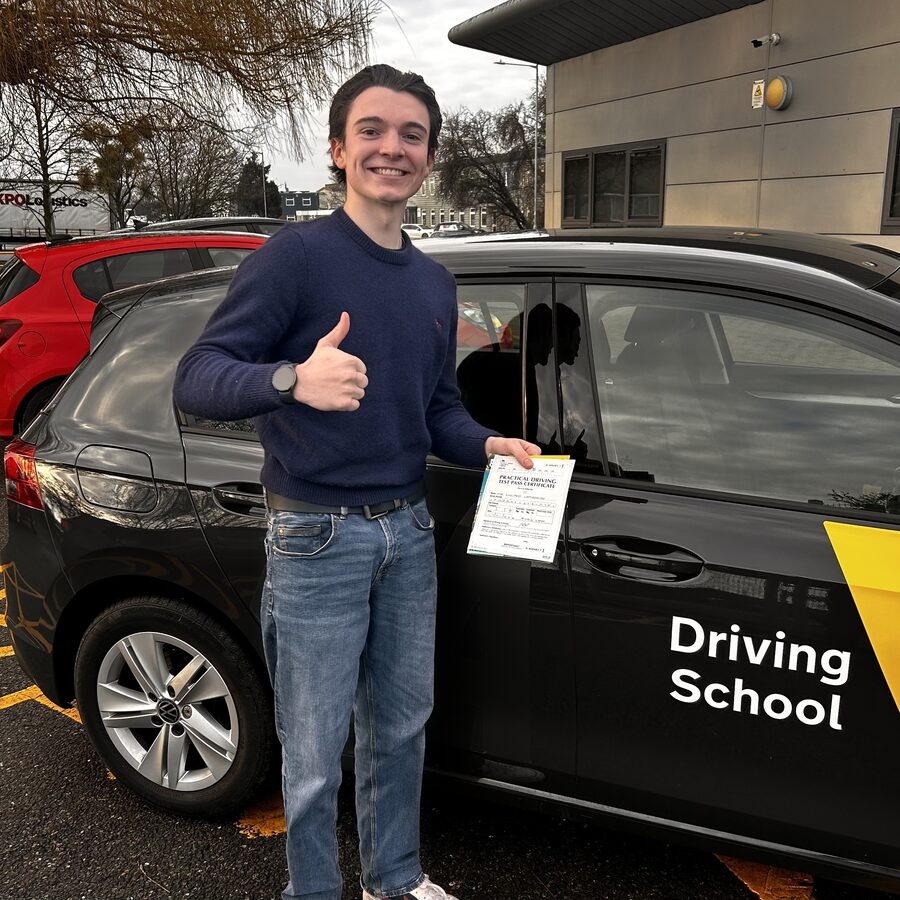 Lucci holding his practical driving test pass certificate